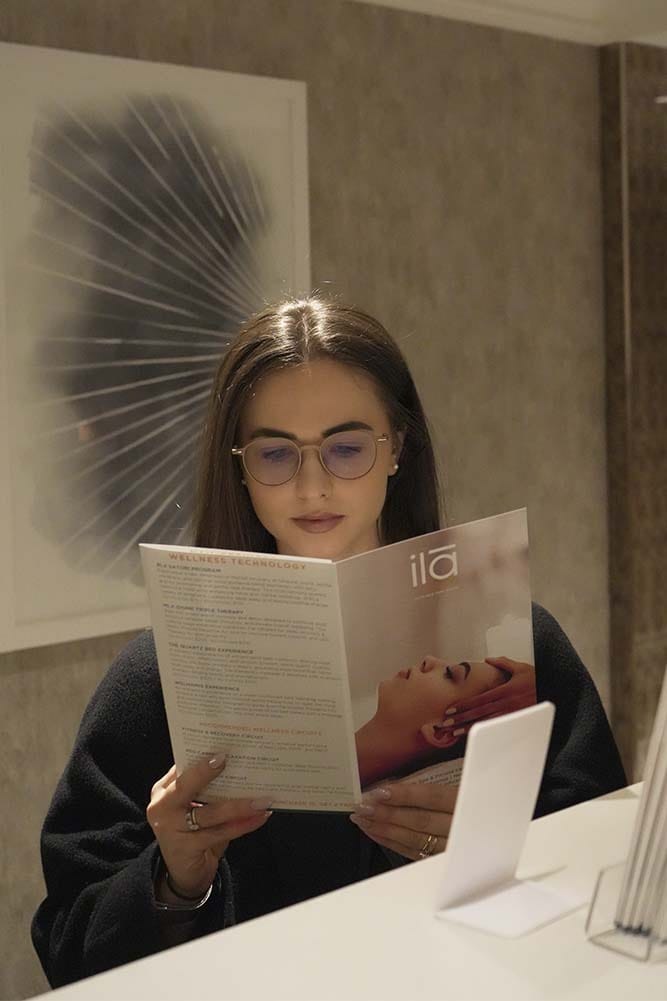 Guest reviewing spa treatment menu at ila Only Spa day spa in Midtown Manhattan New York