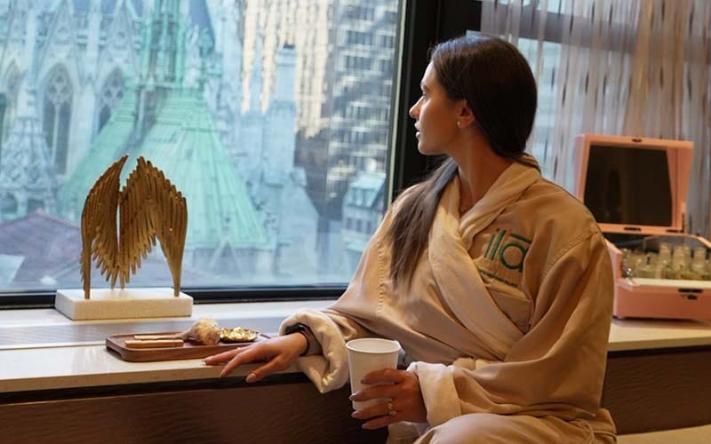 guest relaxing during a luxury spa experience at ila Only Spa overlooking St. Patrick’s Cathedral in Midtown Manhattan NYC