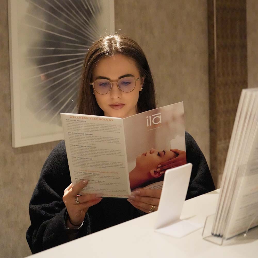 Guest reviewing spa treatments after receiving a massage gift card at ila Only Spa NYC