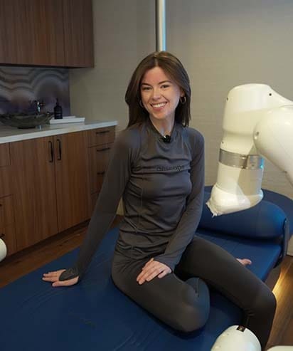 Woman relaxing during an AI robotic massage therapy session at ila Only Spa in Midtown Manhattan New York