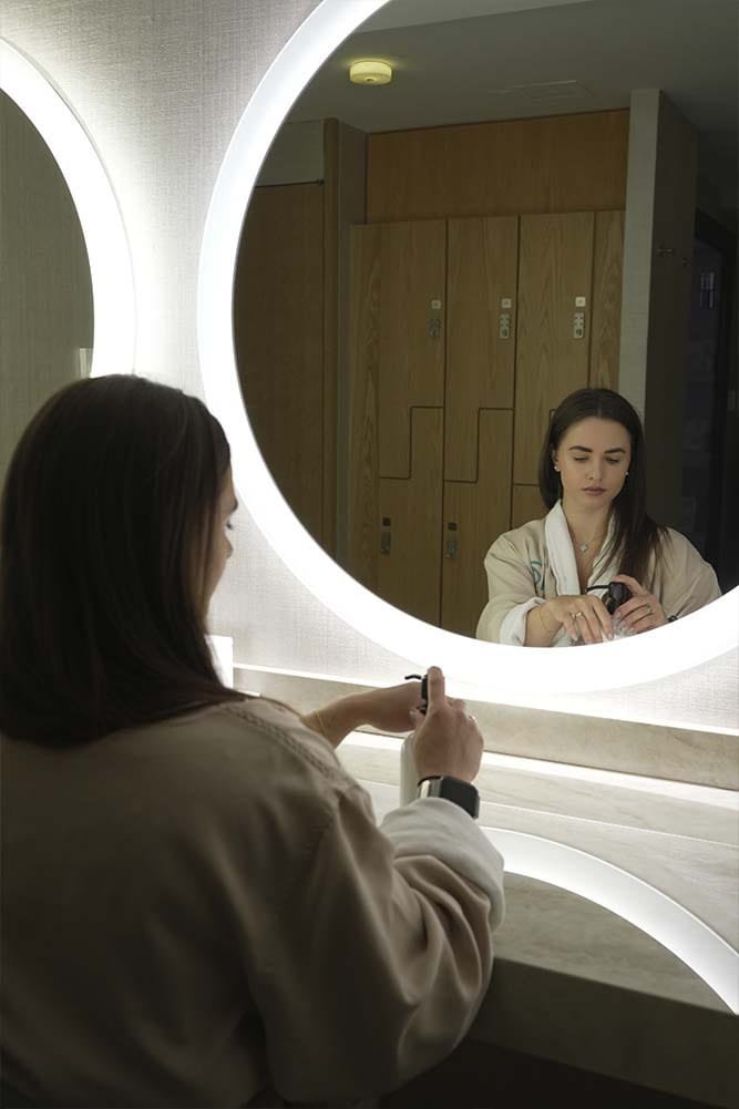 spa guest applying skincare before power collagen facial at ila Only Spa Manhattan