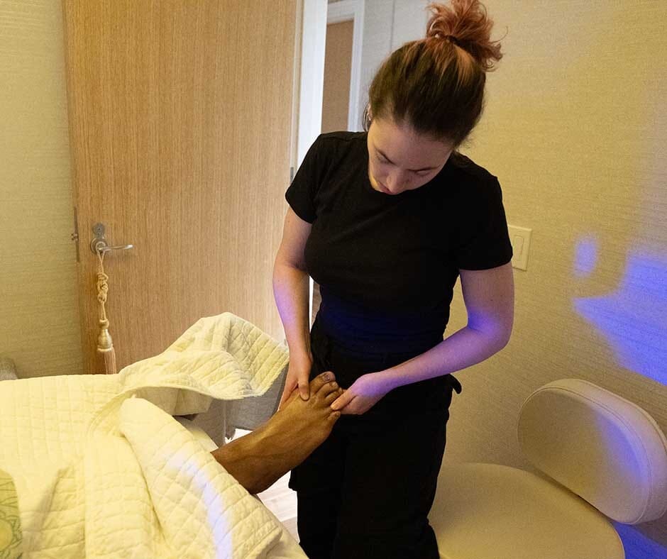 Therapist applying targeted pressure during a foot massage at ila Only Spa in New York City