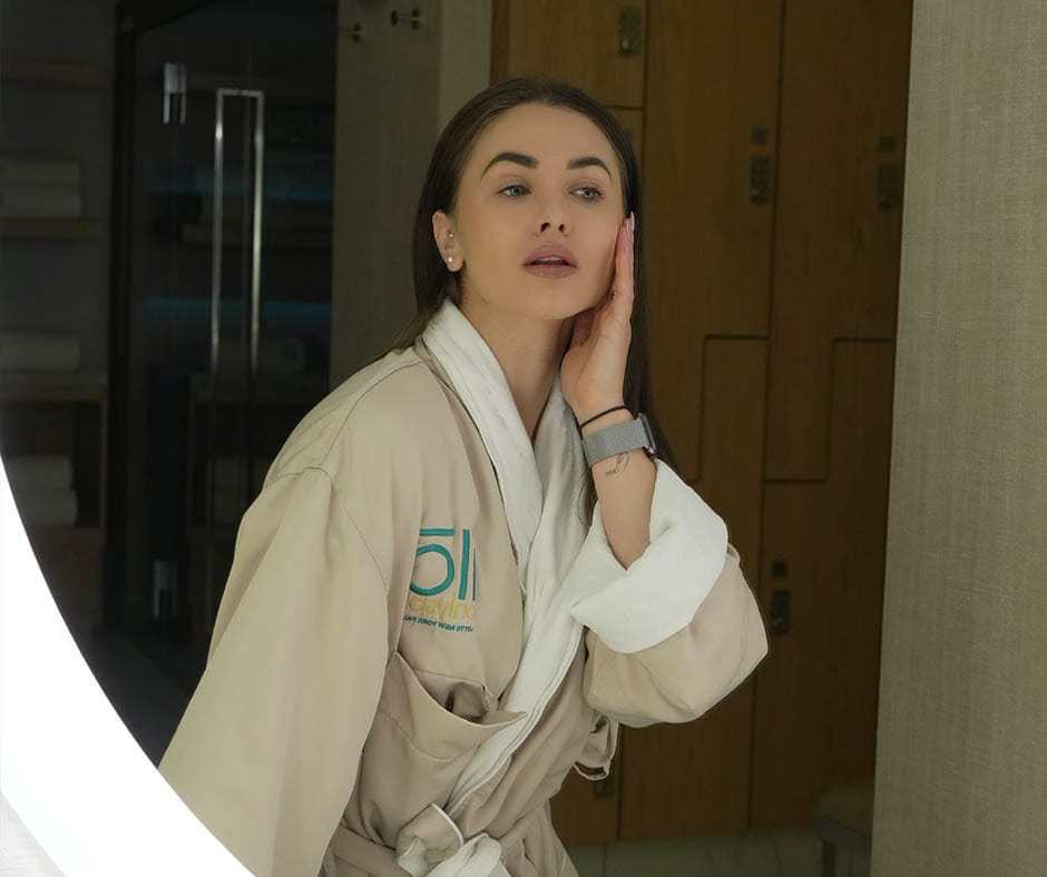 Spa guest admiring her skin after a facial treatment at ila Only Spa in Manhattan, New York City