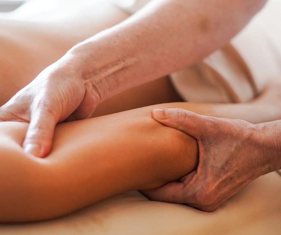 Massage therapist using focused deep tissue pressure during a treatment at ila Only Spa