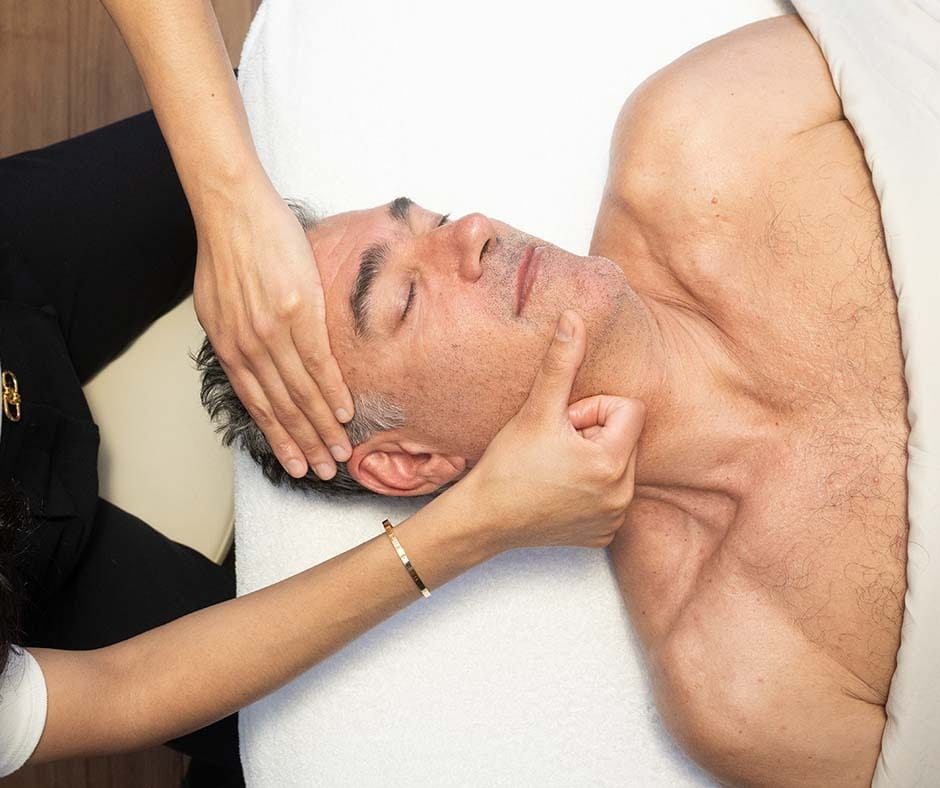 Man receiving a relaxing facial and head treatment at ila Only Spa in NYC
