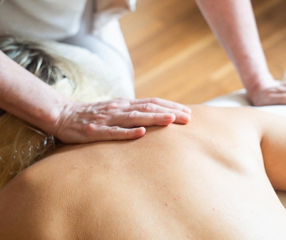 Therapist performing a massage to relieve muscle tension at ila Only Spa in NYC