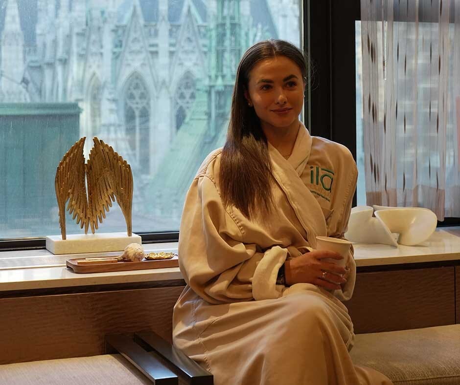 Guest relaxing at ila Only Spa with a New York City view after a wellness treatment