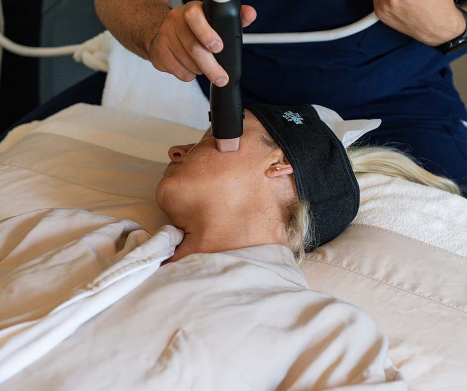 Woman receiving a non-surgical facial skin tightening treatment at ila Only Spa in Midtown Manhattan.